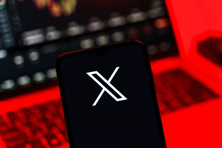 Prague, Czechia - 10 21 2024: Smartphone on surface showing X logo.