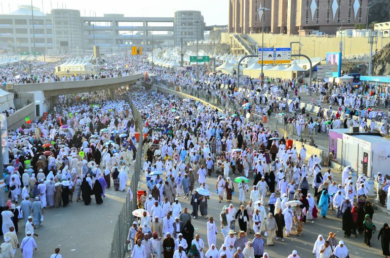 shutterstock_2602807371-1779017210 Mecca, Saudi Arabia - October 16, 2013: A group of Hajj pilgrims walk in the city of Mina to perform the ritual of stoning the devils at Jamarat. Around 2 million people perform the Hajj every year.