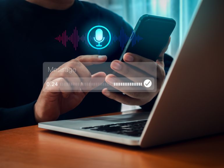 shutterstock_2605610887-1778414787 AI chatbot conversation and voice searching automation, voice recognition technology concept. Personal conversational assistant technology with digital sound wave audio graphic on smartphone in hand.