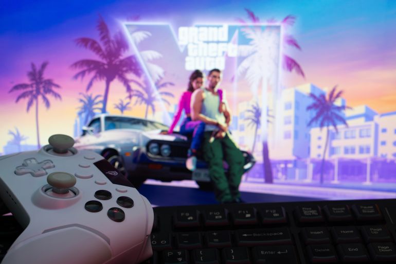 Dhaka, Bangladesh- 11 April 2025: A modern gaming setup featuring a gamepad and keyboard against a vibrant Grand Theft Auto VI background on a computer monitor.