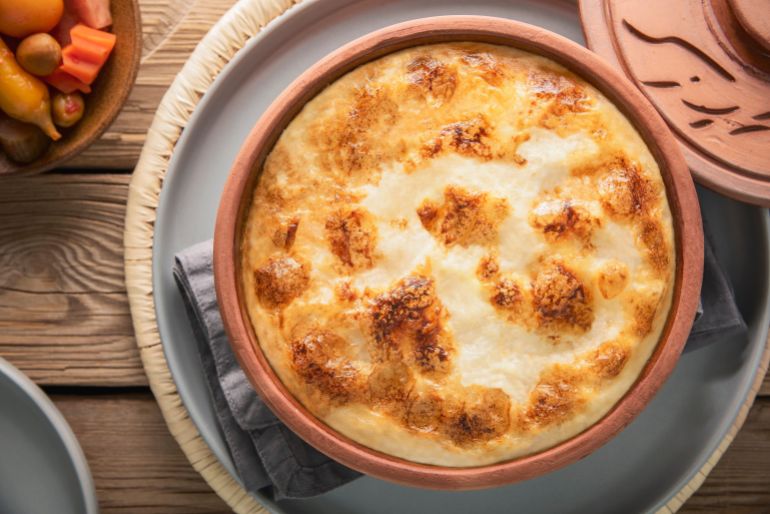 shutterstock_2629027735-1779798391 Arabic Cuisine; Egyptian baked rice ''Muammar Rice''. It's combination of rice, fresh cream and milk. Top view with close up.