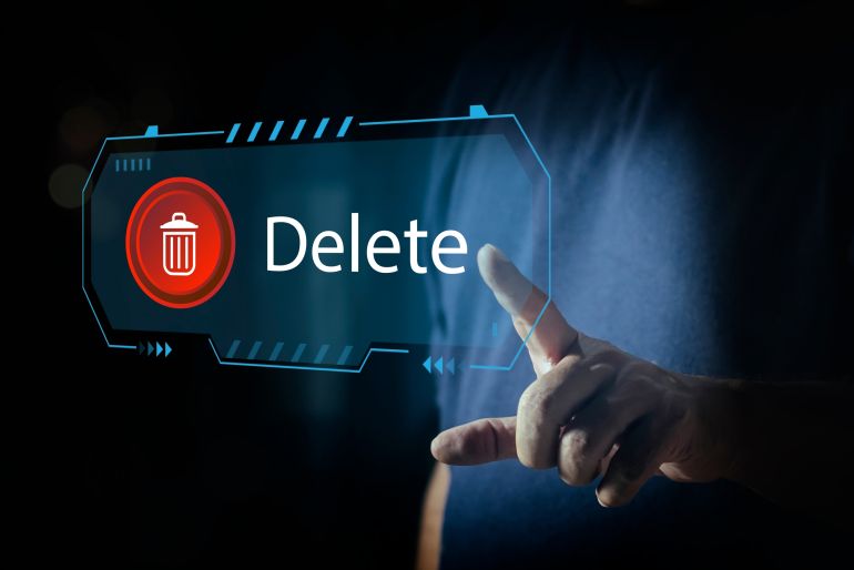 Man pushing the delete button on virtual screen. The concept of deletion or erase contacts, Deleting files from the system. Spam mail, electronic messages or personal data in computer systems.