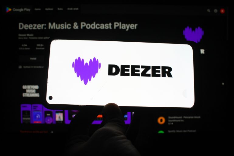 The Deezer logo displayed on a smartphone screen with the Deezer app on the play store in the background. Indonesia - June 21, 2025
