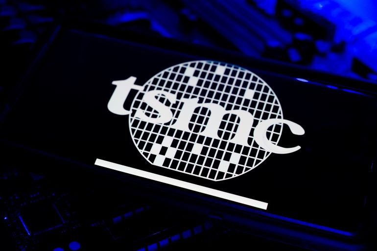 shutterstock_2661823353-1778510401 Los Angeles, California - August 3 2025: TSMC Taiwan Semiconductor Company Logo On Mobile Screen With CPU Motherboard Card Computer Chips Circuit Technology Background