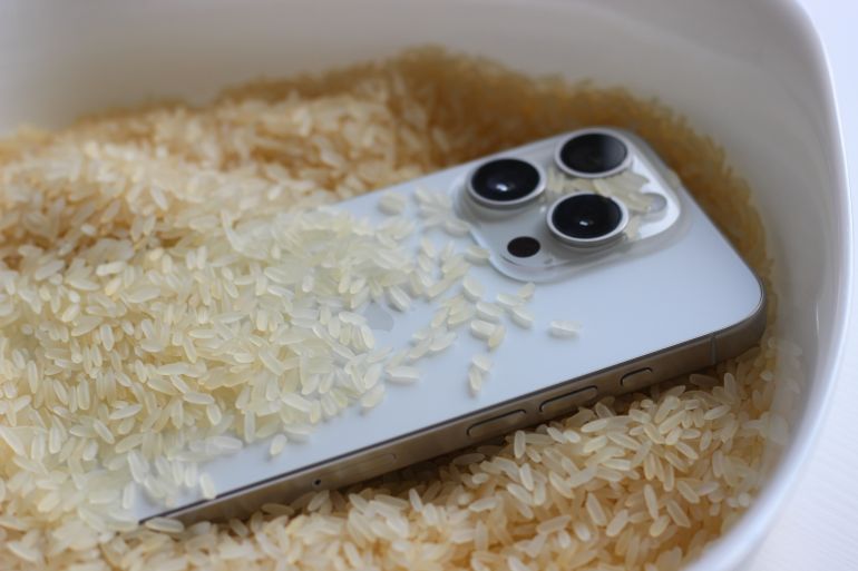 Varash, Ukraine - July, 20, 2025: Smartphone placed in rice as a common home remedy after water damage
