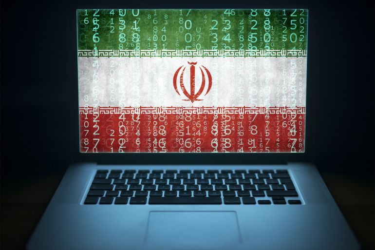 Iranian hacker laptop with binary computer code and Iran flag on the screen. Internet and network security.