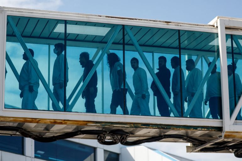 Venezuelan migrants walk a jet bridge upon arrival on an Eastern Airlines plane from the United States, at Simon Bolivar International Airport, in Maiquetia, Venezuela, January 16, 2026. REUTERS/Leonardo Fernandez Viloria