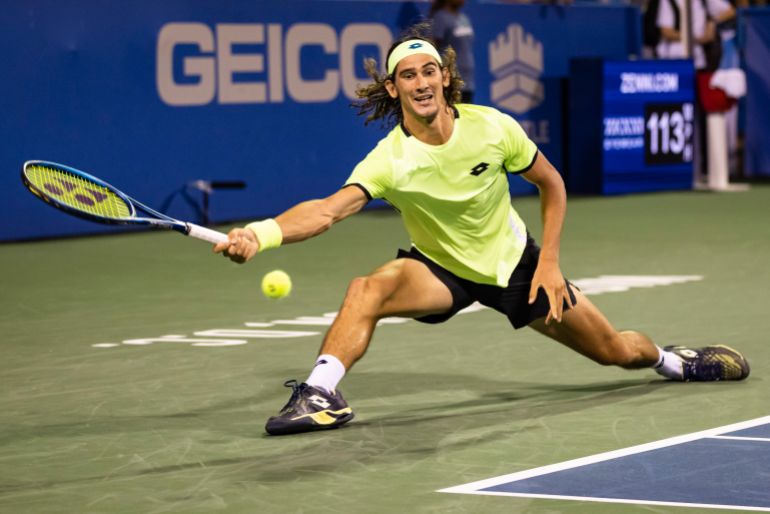 Aug 5, 2021; Washington, DC, USA; Lloyd Harris of South Africa slides to hit a shot against Rafael Nadal of Spain (not pictured) during the Citi Open at Rock Creek Park Tennis Center. Mandatory Credit: Scott Taetsch-USA TODAY Sports
