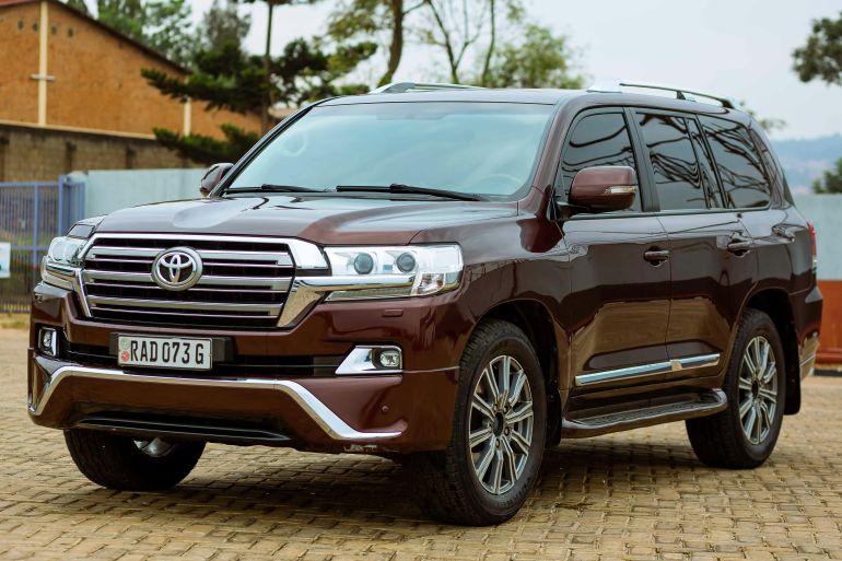 twywta-1779384523 Elegant Toyota Land Cruiser parked on a cobblestone driveway during the day.