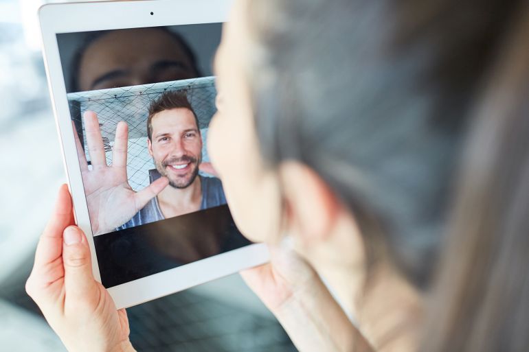 Young couple in long-distance relationship communicating online via video chat