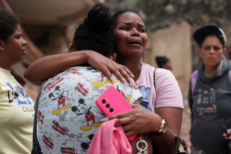 A woman reacts as she thinks a family member is trapped in the rubble, after earthquakes hit the country, in La Guaira, Venezuela, June 25, 2026. REUTERS/Gaby Oraa