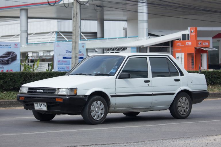 15zx-1780833367 CHIANG MAI, THAILAND -NOVEMBER 28 2017: Private Old car, Toyota Corolla. Photo at road no 121 about 8 km from downtown Chiangmai, thailand.