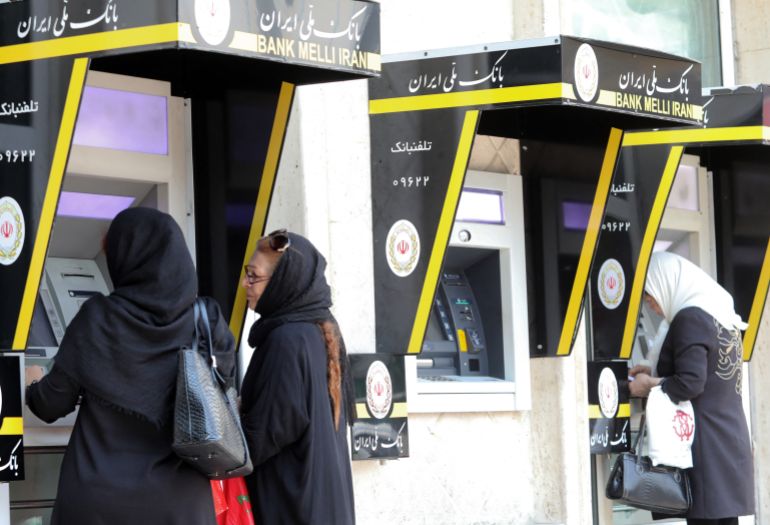 1bank-melli-iran-1781423763-1 Iranian women use automated teller machines (ATM) in the capital Tehran on May 20, 2019. US President Donald Trump issued an ominous warning to Iran yesterday, suggesting that if the Islamic republic attacks American interests, it will be destroyed. (Photo by ATTA KENARE / AFP)