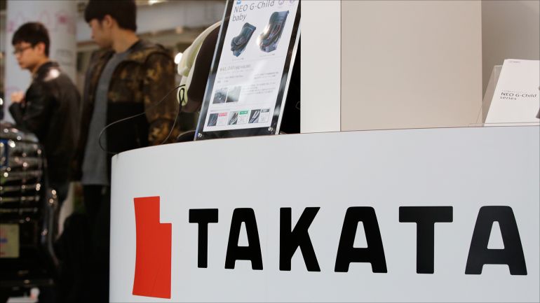 2c01b67e-f4fa-4bd1-970a-b6f7a05359d7 epa05878428 Visitors walk next to Japanese auto safety parts maker Takata Corp. products displayed at a Tokyo Motor showroom in Tokyo, Japan, 30 March 2017. Toyota Motor recalled about 2.9 million vehicles worldwide due to potentially faulty airbag inflators made by Takata. It is estimated that the recall affects around 750,000 vehicles in Japan, 650,000 in China, 350,000 in Europe and 1.16 million in other areas. EPA/KIMIMASA MAYAMA