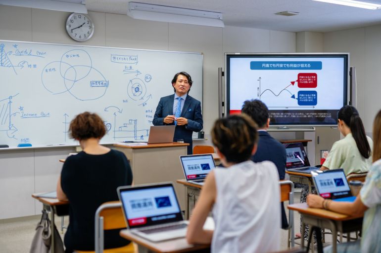 2schools-in-japan-1781604169 Professor teaching mid adult and mature students at a community college or university class in Japan