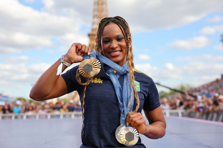 2sports-1781693719 PARIS, FRANCE - AUGUST 07: Women's Artistic Gymnastics medalist Rebeca Andrade of Team Brazil poses for a photo with her medals on day twelve of the Olympic Games Paris 2024 at Champions Park on August 07, 2024 in Paris, France. (Photo by Michael Reaves/Getty Images)