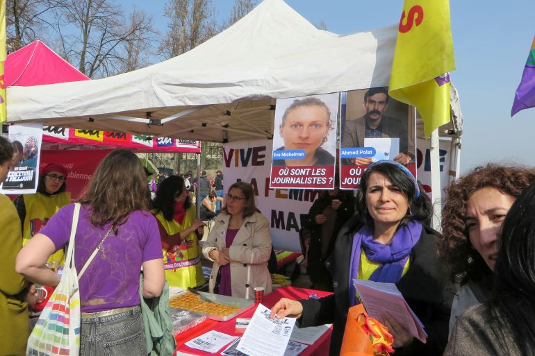 51-1781943966 PARIS, FRANCE - 2026/03/08: Activists stand at an information booth displaying posters of missing Kurdish journalists Eva Michelman and Ahmed Polat during the International Women's Day march. Demonstrators gathered in Paris on March 8, 2026, marking International Women's Day with rallies and marches calling for gender equality, women's rights, and solidarity with women facing discrimination and violence worldwide. (Photo by Siavosh Hosseini/SOPA Images/LightRocket via Getty Images)