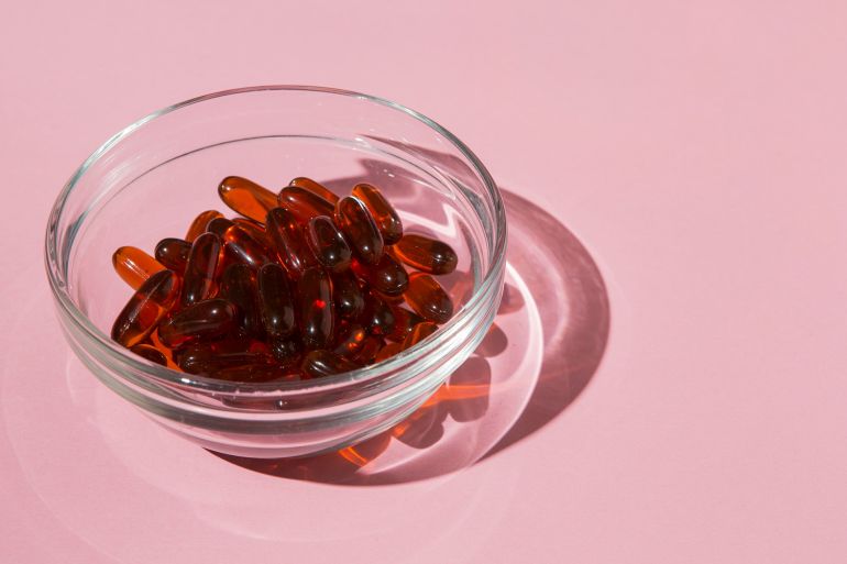 Bowl filled with medical capsules @فري بيك