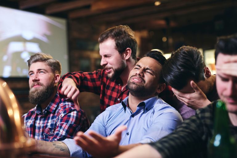 Scene of annoyed fans in the pub by gpointstudio @ادوبي ستوك