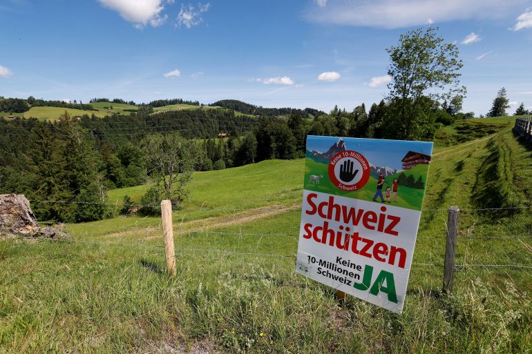 679876cabfgh-1781462519 A sign sits in a field, on the day of the vote on a plan backed by the right-wing Swiss People's Party (SVP) to limit population growth to 10 million inhabitants, in Hundwil, Switzerland, June 14, 2026. REUTERS/Michaela Stache