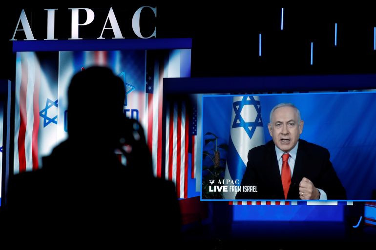 Speaking via satellite feed from Israel, Israeli Prime Minister Benjamin Netanyahu addresses AIPAC in Washington, U.S., March 26, 2019. REUTERS/Kevin Lamarque