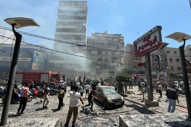 8787yu7-1781440552 People gather at the site of an Israeli airstrike that targeted a building in Beirut’s southern suburbs on June 14, 2026.