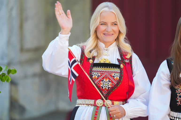 (FILES) Crown Princess Mette-Marit greets the children's parade during the May 17 celebrations at the Royal residence, Skaugum, west of the Norwegian capital Oslo, on May 17, 2024.