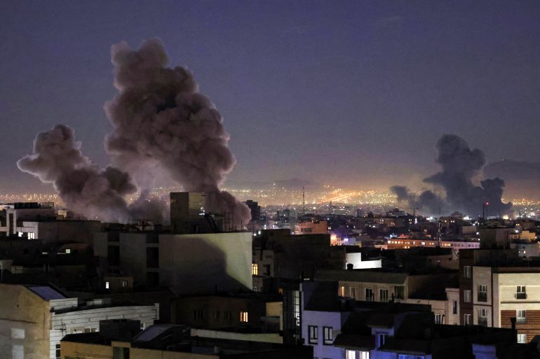 afp_69a49fbbcaa3-1772396475 TOPSHOT - Smoke plumes rise following missile strikes in Tehran on March 1, 2026.