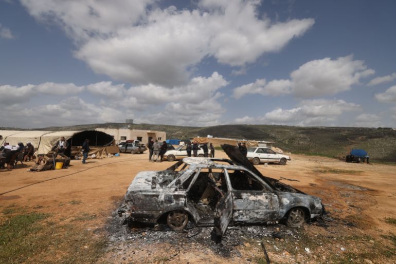 afp_69d758cd8b45-1775720653 Palestinians stand near a vehicle that was destroyed following an Israeli settlers attack on the outskirts of Al-Lubban ash-Sharqiya village, south of Nablus in the occupied West Bank, on April 6, 2026.