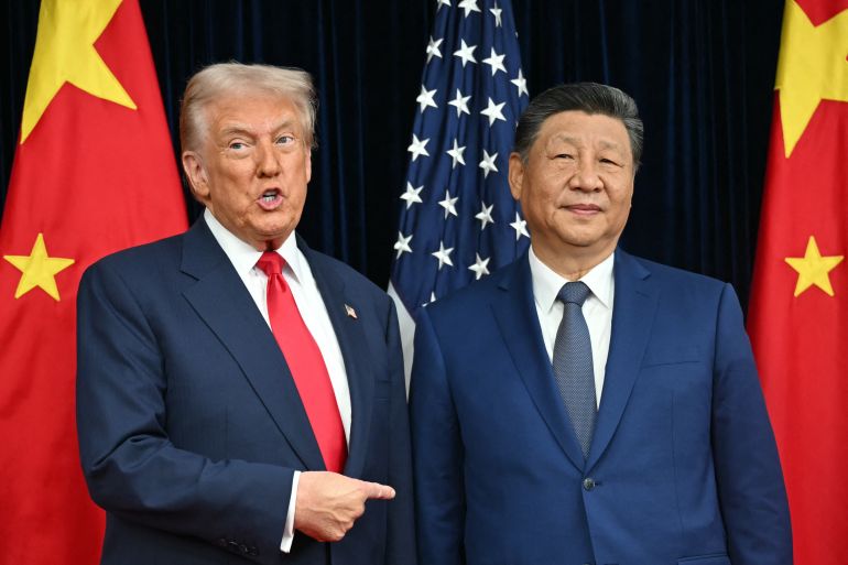 afp_6a0365854943-1778607493 (FILES) US President Donald Trump (L) and China's President Xi Jinping greet each other as they arrive for talks at the Gimhae Air Base, located next to the Gimhae International Airport in Busan on October 30, 2025.