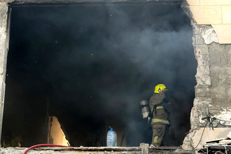 A rescue worker enters a smoke filled apartment block following an Israeli air strike in the Choueifat area, south of Beirut on the outskirts of the capital’s southern suburbs, on May 28, 2026.