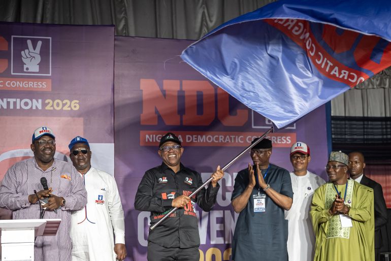 Peter Obi (C), presidential candidate of the Nigeria Democratic Congress (NDC), waves the party's flag after being affirmed as the party's flag bearer during the NDC Special Convention in Abuja on May 30, 2026. (Photo by Light Oriye Tamunotonye / AFP)