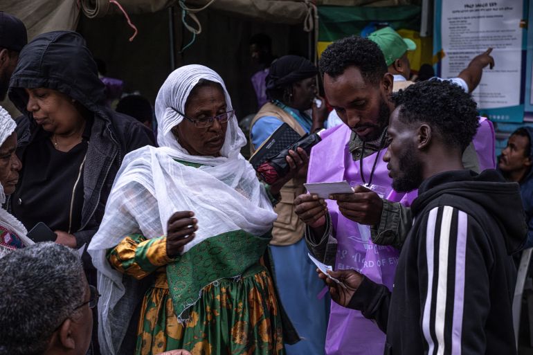 afp_6a1d6aae7366-1780312750 Voters seek information about their voter registration cards from National Election Board of Ethiopia (NEBE) officials outside a polling station at Shalla Park in Addis Ababa, on June 1, 2026, during the 2026 Ethiopian parliamentary elections.