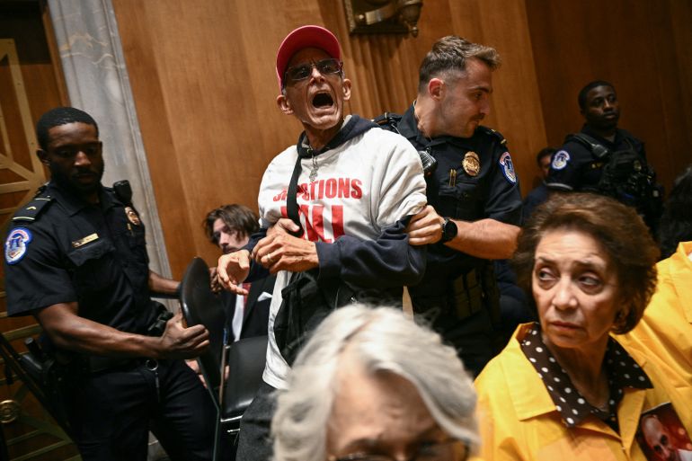 afp_6a1ee8f3bcb4-1780410611 Demonstrators protesting the war in Iran are removed by US Capitol Police officers as US Secretary of State Marco Rubio testifies during a Senate Foreign Relations Committee hearing conerning the fiscal year 2027 budget for the State Department, on Capitol Hill in Washington, DC, on June 2, 2026.