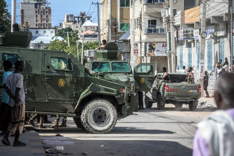 TOPSHOT - Somali government forces ride in armoured vehicles during a patrol as residents gather following reported shelling in the Howl Wadaag district of Mogadishu, on June 4, 2026.