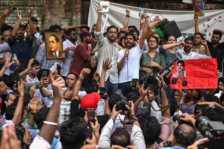 Cockroach Janta Party (CJP) founder Abhijeet Dipke (C, right) shouts slogans during a protest over alleged irregularities in the country's major examinations, in New Delhi on June 6, 2026.