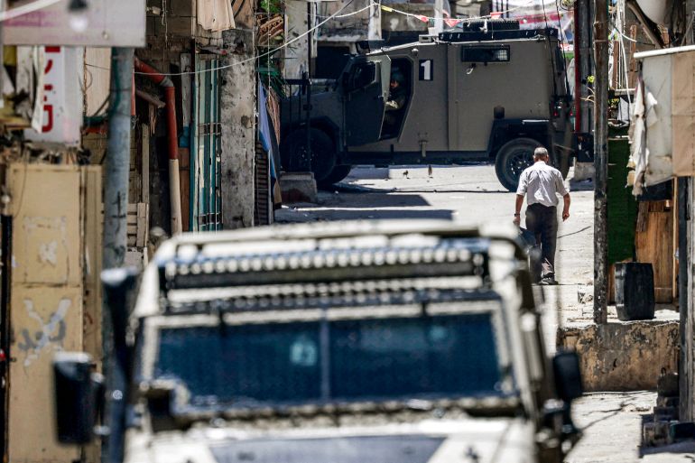 afp_6a2555d3b693-1780831699 Israeli army armoured vehicles move along alleys in the Balata camp for Palestinian refugees, east of Nablus in the occupied West Bank, during an Israeli military operation on June 7, 2026.