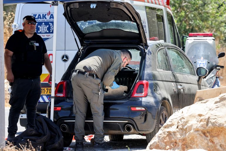 afp_6a258c60a880-1780845664 Members of Israel's ZAKA search and rescue emergency services inspect the vehicle of a victim in a suspected shooting attack in the town of Tzur Yitzhak in central Israel close to the occupied West Bank on June 7, 2026.