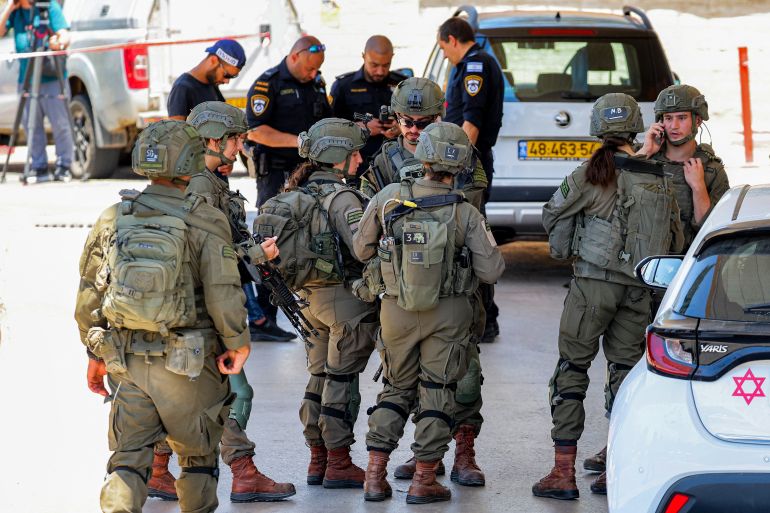 afp_6a258e129bfe-1780846098 Israeli security forces gather at a petrol station following a suspected shooting attack near the town of Kokhav Yair in central Israel close to the occupied West Bank on June 7, 2026.