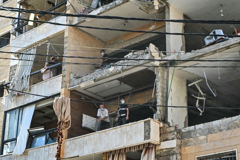 First responders inspect damage at the site of an Israeli airstrike targeting apartments in a residential building in Beirut's southern suburbs on June 7, 2026.