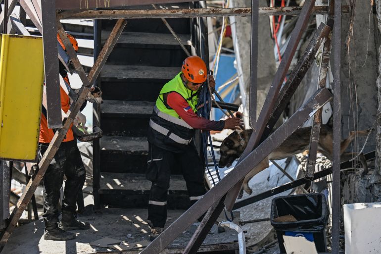 afp_6a2806767168-1781007990 Responders and rescue dogs conduct search and rescue operations in the collapsed building after a 7.8 magnitude earthquake in General Santos City on June 9, 2026.