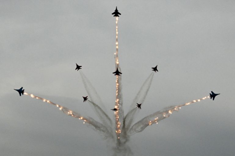Russia's MiG-29 jet fighters of the Strizhi (Swifts) and Su-30SM jet fighters of the Russkiye Vityazi (Russian Knights) aerobatic teams perform during the International Maritime Defence Show "Fleet" 2026 in Kronstadt on June 10, 2026. (Photo by Olga MALTSEVA / AFP)