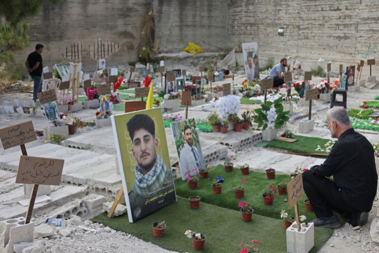 afp_6a2bbad3972b-1781250771-1 Hussein Tufayli (R) mourns over the grave of his son Mohammed Tufayli, a Hezbollah fighter who was killed during the ongoing war, at a temporary cemetery in the southern coastal Lebanese city of Sidon on June 11, 2026.