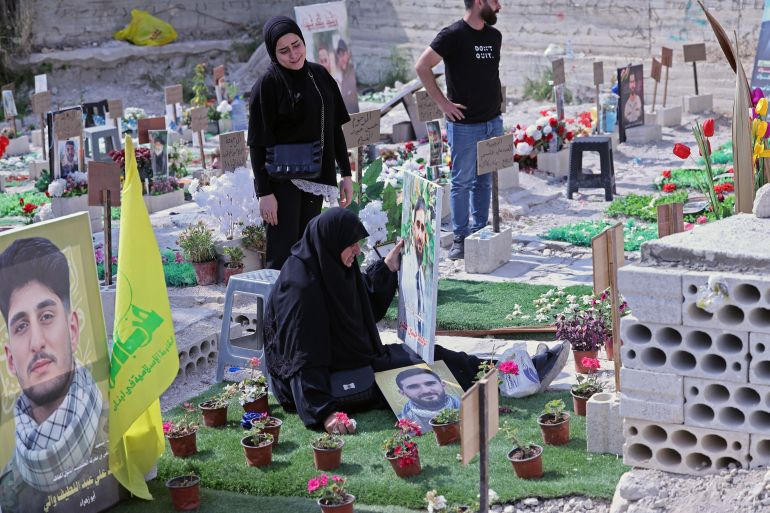 afp_6a2bbaf528df-1781250805 Ghada Hussein (C) mourns over the grave of her son Mohammed Tufayli, a Hezbollah fighter who was killed during the ongoing war, at a temporary cemetery in the southern coastal Lebanese city of Sidon on June 11, 2026.