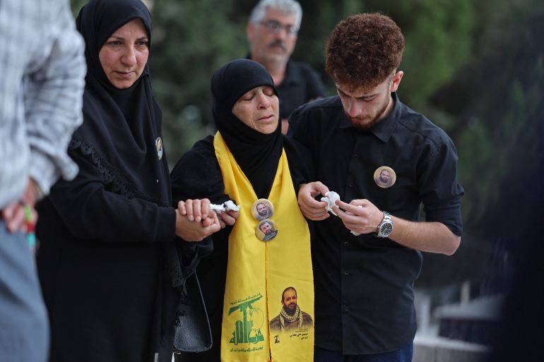 afp_6a2bbb319691-1781250865 Mourners comfort the mother of Hezbollah fighter Hassan Ali Kallas, from the southern Lebanese village of Nabatieh al Fawka, during his funeral at a temporary cemetery in the southern coastal Lebanese city of Sidon on June 11, 2026.