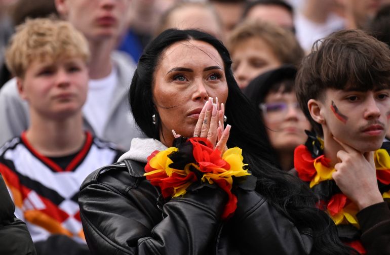 Germany fans react after the 1-1 goal at the public screening of Germany's opening match at the 2026 World Cup against Curacao at the former coal mine 'Ewald' in Herten, western Germany on June 14, 2026.