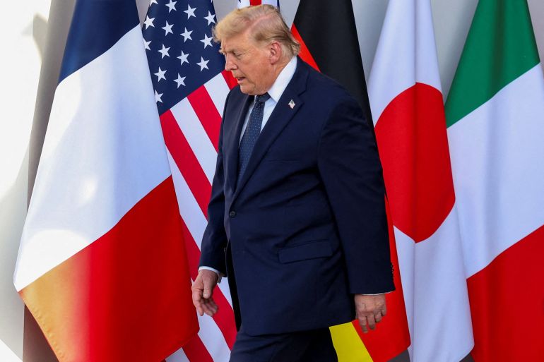afp_6a305cb6bd5a-1781554358 US President Donald Trump arrives for the official greeting during the G7 summit, in Evian, eastern France, on June 15, 2026.