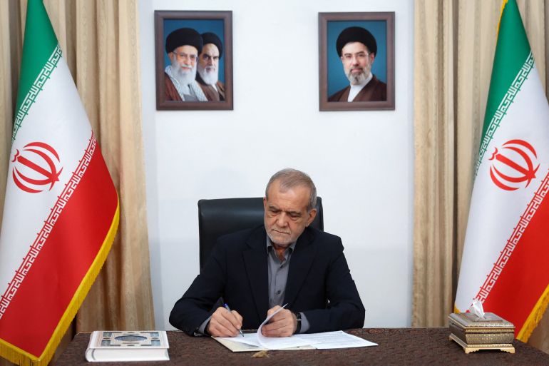 This handout picture released by the Iranian Presidency shows Iran's President Masoud Pezeshkian signing a memorandum of understanding in Tehran on June 18, 2026.