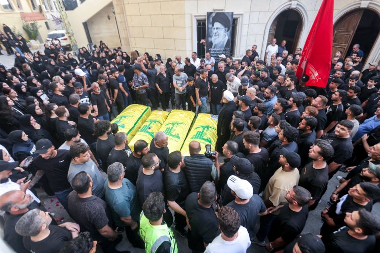 afp_6a38d5130574-1782109459 EDITORS NOTE: Graphic content / Mourners gather before the Hezbollah flag-draped bodies of four women who were killed the previous day following Israeli bombardment on the village of Qannarit, south of Sidon in southern Lebanon, during the funeral in the village on June 21, 2026.