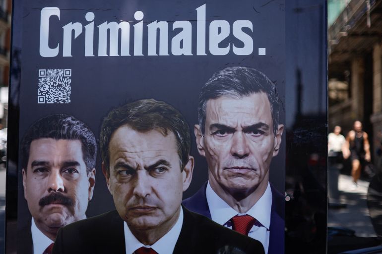 afp_6a3ace5f2577-1782238815 A poster depicting ousted Venezuelan President Nicolas Maduro, former Spanish Prime Minister Jose Luis Rodriguez Zapatero, and Spain's Prime Minister Pedro Sanchez with the word "Criminals" hangs on an urban furniture digital display on a street adjacent the National Court where Zapatero, who governed Spain from 2004 to 2011, was questioned by a judge as part of an investigation for alleged influence peddling, in Madrid, on June 17, 2026.